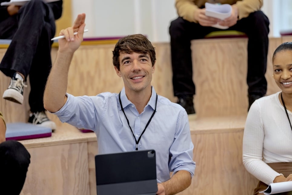 Conference attendee raising hand