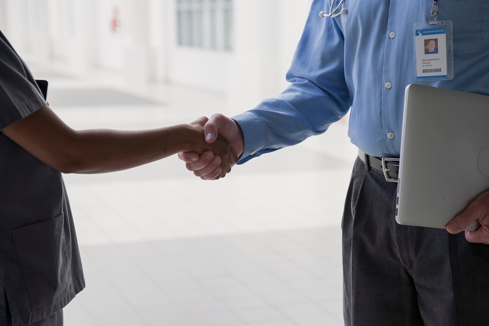 Healthcare professionals shaking hands